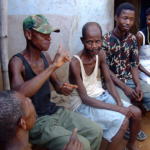 A_group_of_deaf_people_chatting_in_a_compound