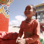 A young pilgrim in a Tibetan location (Photo: Dan Smyer Yu)