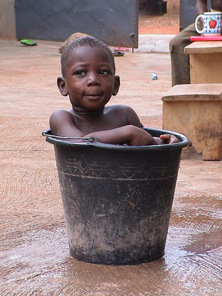 Boy in Bucket (Dormaa Ahenkro, Ghana). (Photo: Boris Nieswand)