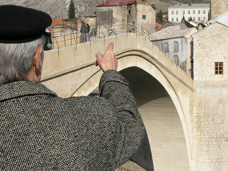 Old man from Mostar sharing his memories at the reconstructed Ottoman bridge, Mostar, Bosnia and Herzegovina. (Photo: Monika Palmberger)