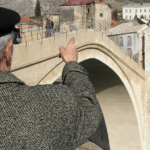 Old man from Mostar sharing his memories at the reconstructed Ottoman bridge, Mostar, Bosnia and Herzegovina (Photo: Monika Palmberger)
