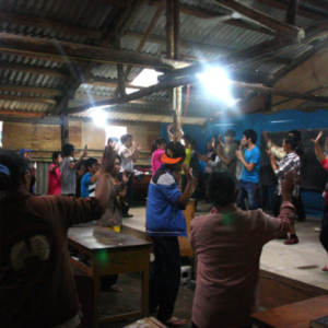 Students rehearsing daibbit dance in the makeshift classroom, Gongshan County, 15 July 2014. (Photo: Ying Diao)