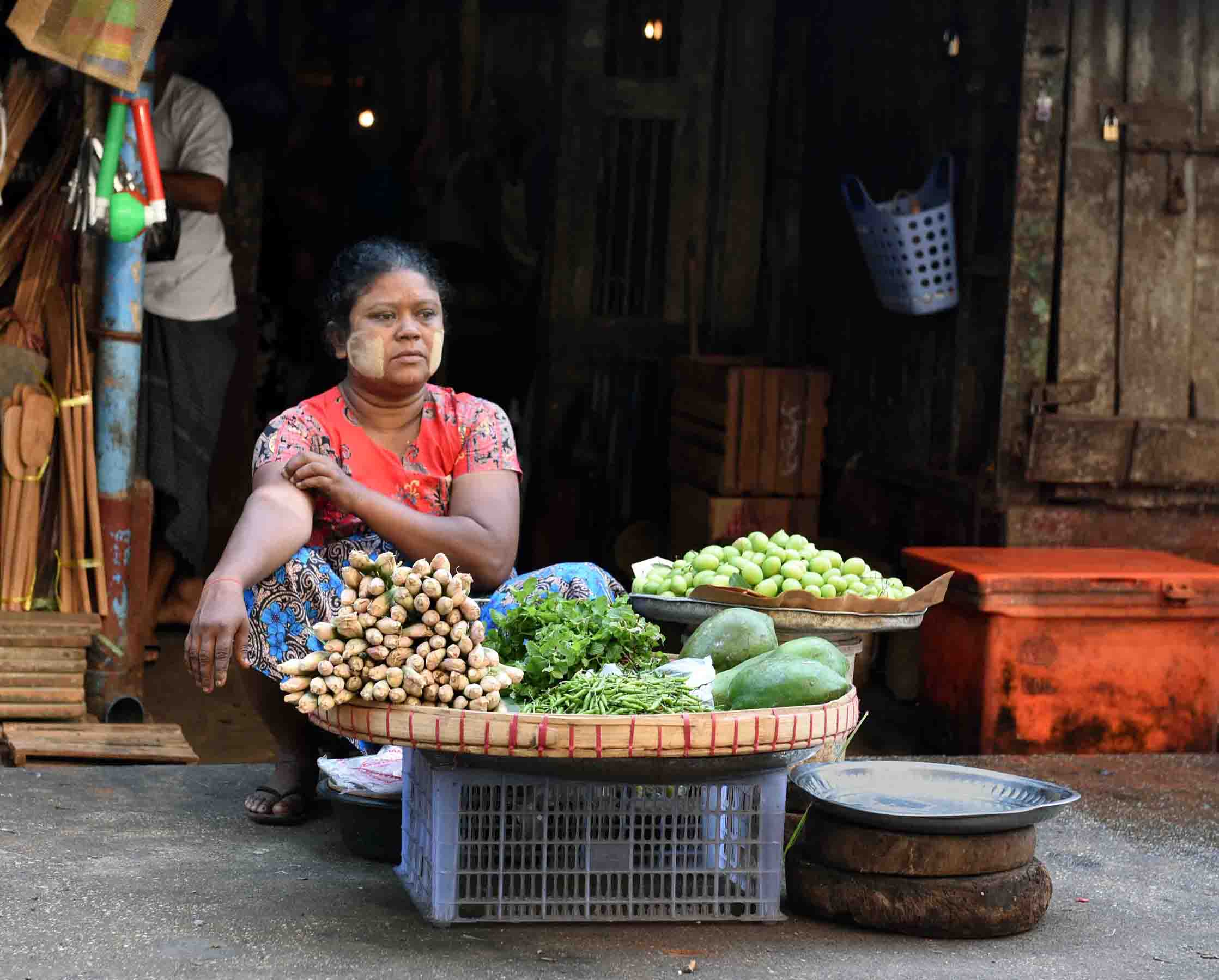 A market vendor selling vegetables. (Photo: Naomi Hellmann)