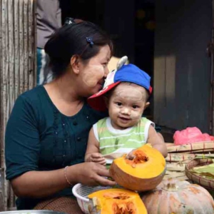 Selling pumpkins and shelling peas at a market in downtown Yangon. (Photo: Naomi Hellmann)