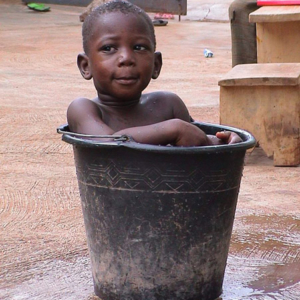 Boy in Bucket (Dormaa Ahenkro, Ghana). (Photo: Boris Nieswand)
