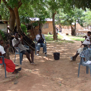 Deaf people chatting under the trees. (Photo: Annelies Kusters)