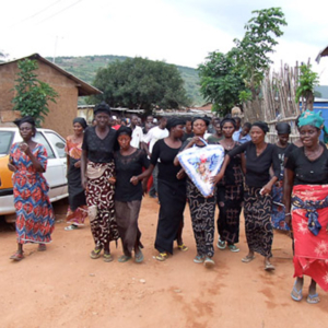 Deaf women carrying a wreath during a deaf man’s funeral. (Photo: Annelies Kusters)