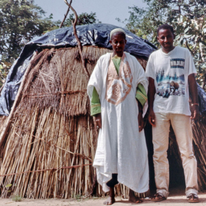 Fulani nomad and young urban Fulani in front of a moveable traditional hut (close to M’Bengué, Côte d’Ivoire). (Photo: Boris Nieswand)