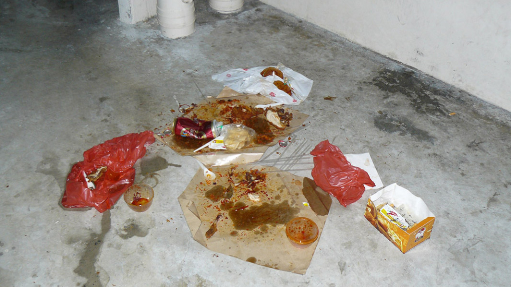 Remnants of a take-away dinner left behind on the void deck floor of a block of public housing (HDB) flats. Low wage South Asian migrants housed in nearby worker dormitories are typically held responsible for such use of public space. Littering is an offence that carries a heavy penalty in the high policed city-state of Singapore. (Photo: Laavanya Kathiravelu)