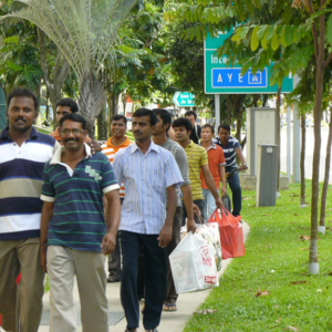 The walkway that runs parallel to government-built public housing is part of the route that low wage migrants take from their dormitories to the train station. Although the passage through this middle class space is part of everyday routines, interaction between these two groups of residents is rare. (Photo: Laavanya Kathiravelu)