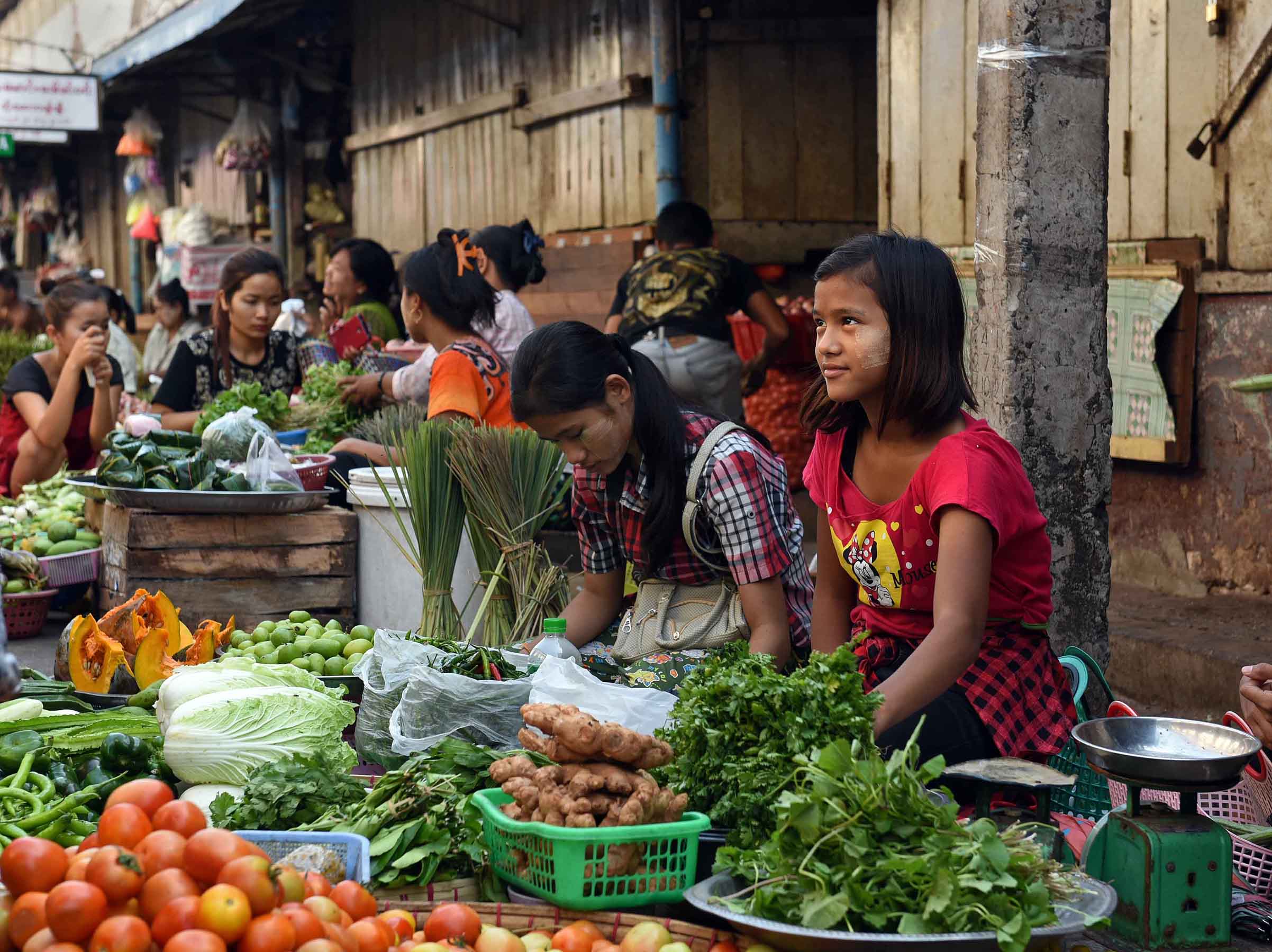 Young women selling fresh vegetables. (Photo: Naomi Hellmann)