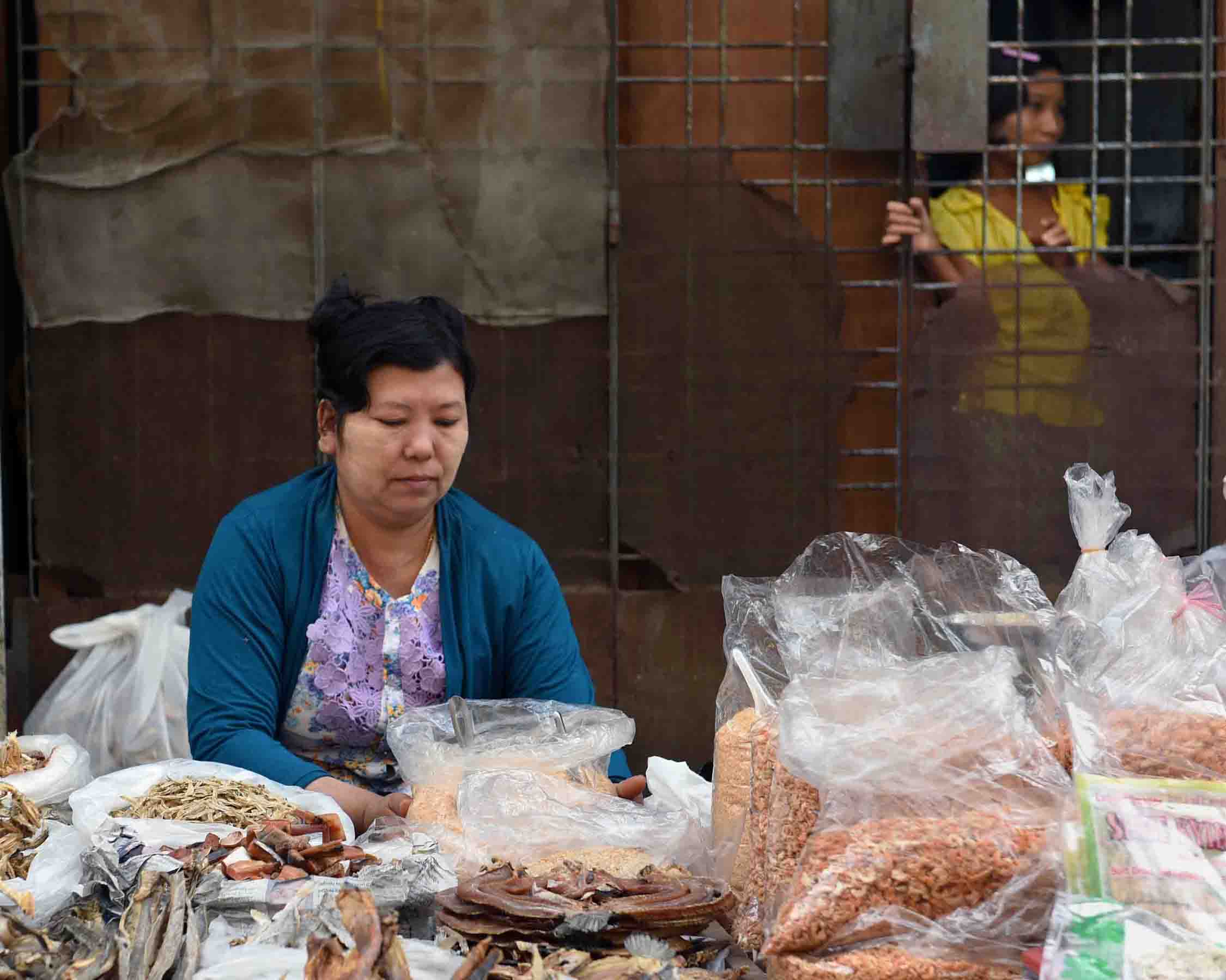 A woman selling assorted dried fish products. (Photo: Naomi Hellmann)