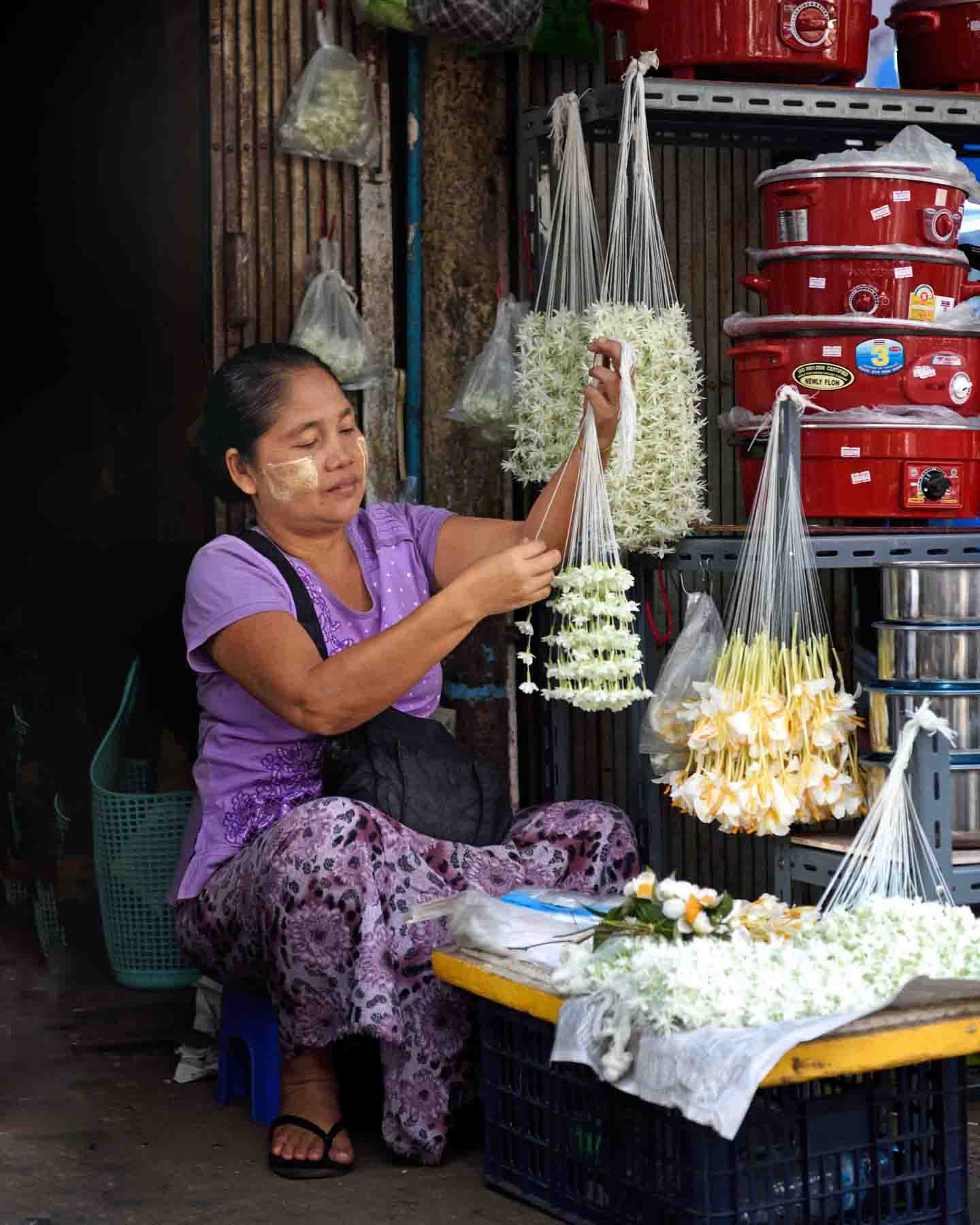 Selling garlands of fresh Jasmine and June flowers, a fragrant, auspicious flower used like lei and as hair decorations as well as temple offerings for Buddhist deities. (Photo: Naomi Hellmann)